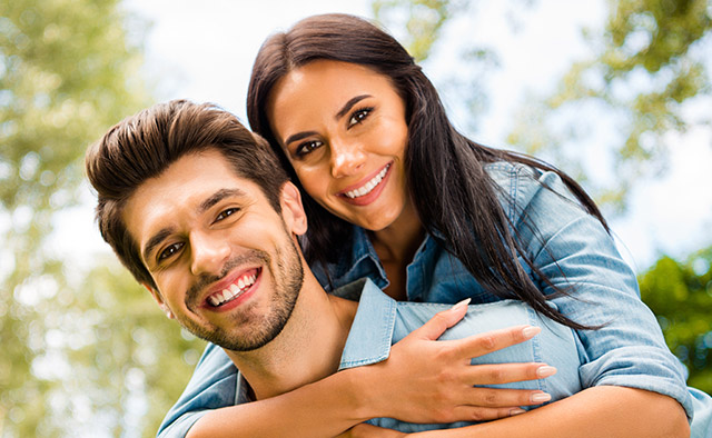 Image of a couple with trees in the background