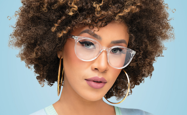 A person with curly hair wearing glasses