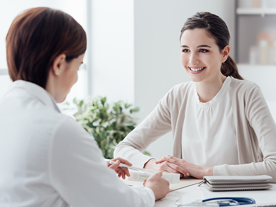 Two woman sitting at a table talking